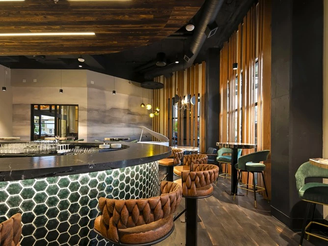 a bar with chairs and a counter