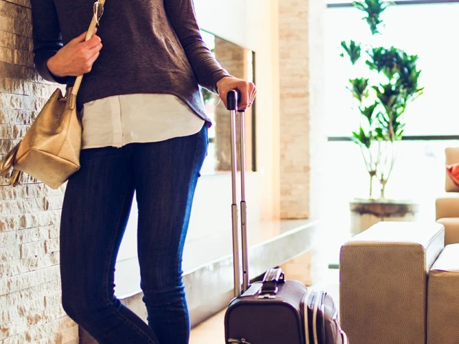 a woman pulling luggage