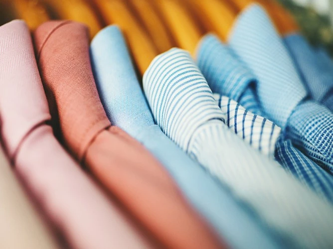 a close-up of a person's hand with a blue and white striped shirt