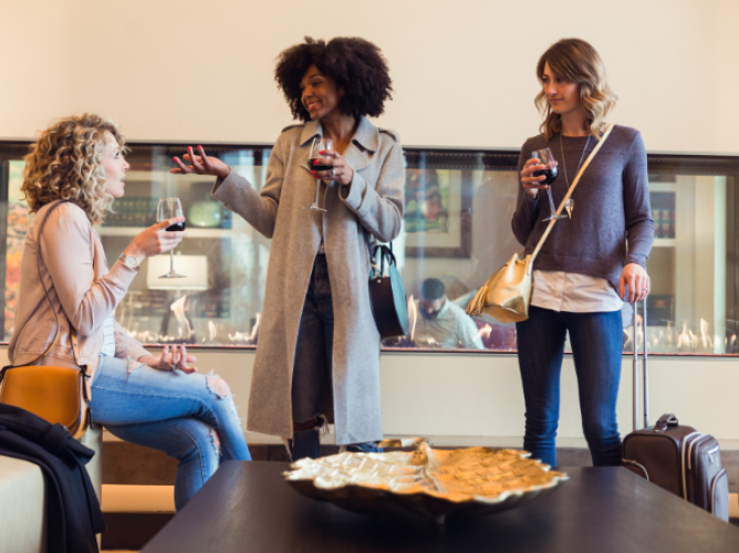 a group of women holding wine glasses