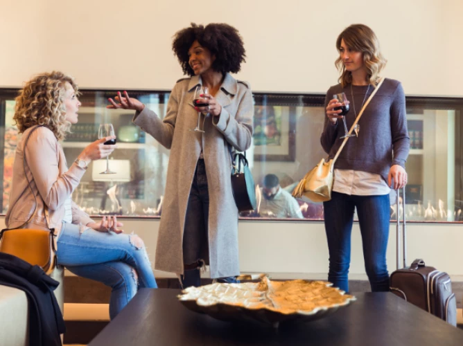 a group of women holding wine glasses