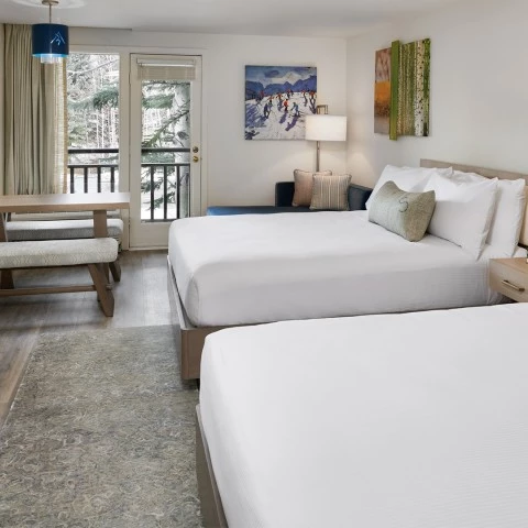 a room with two beds and a table