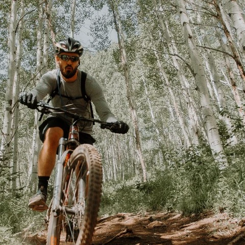 a man riding a bike through the woods