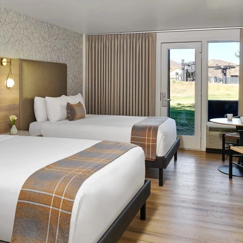 a room with two beds and a table