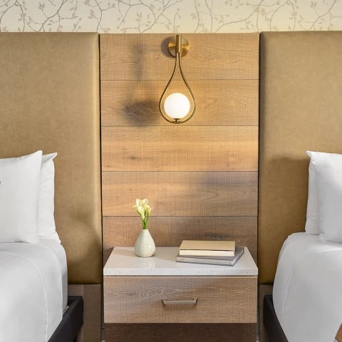 a room with two beds and a table