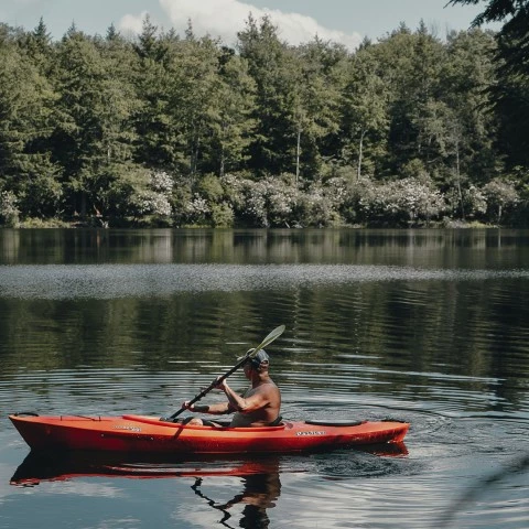 a man in a kayak on a lake