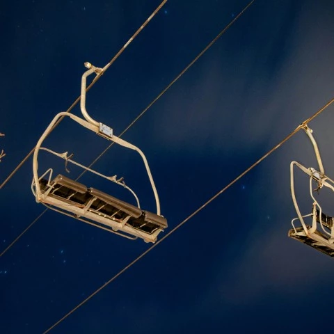 a ski lift chairs on wires