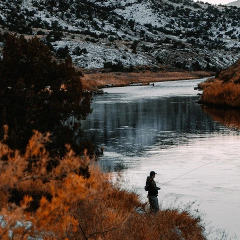 a man fishing in a river