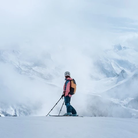 a person on skis on a snowy mountain
