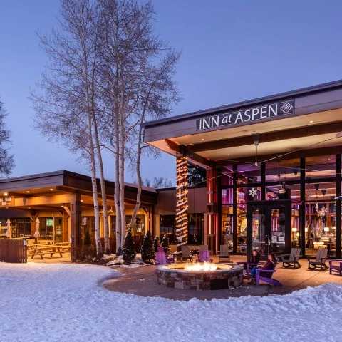 a building with a fire pit in front of it