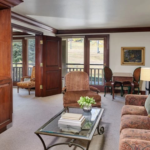 a living room with a glass table and chairs