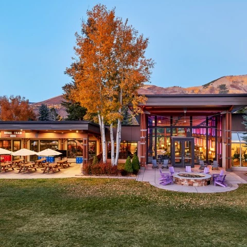 a building with a fire pit and trees
