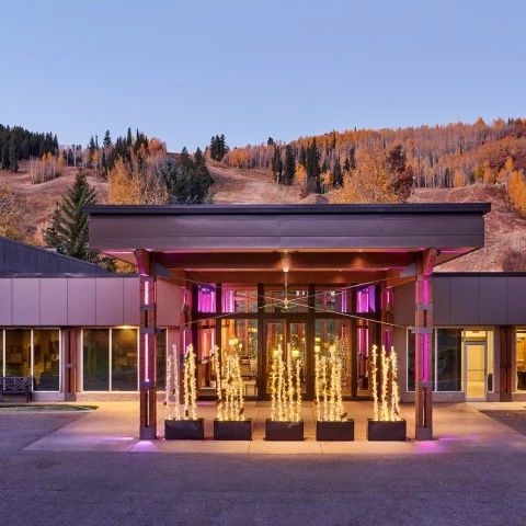 a building with lights and trees in the background