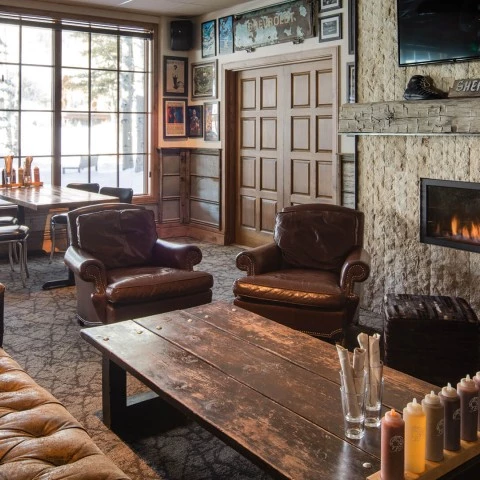 a room with a fireplace and chairs