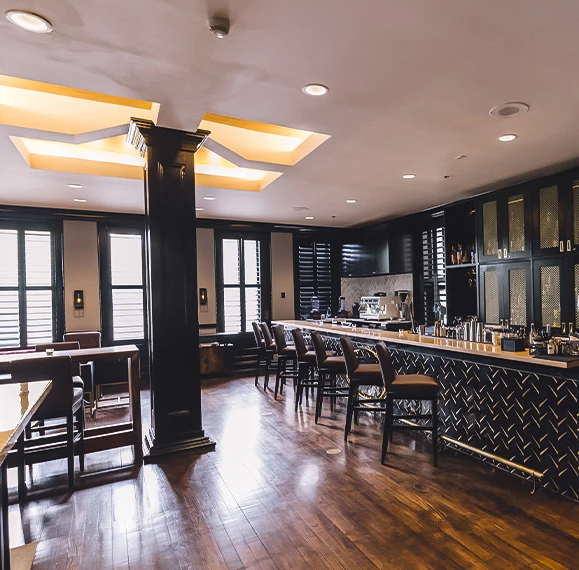 a room with a bar and a wooden floor