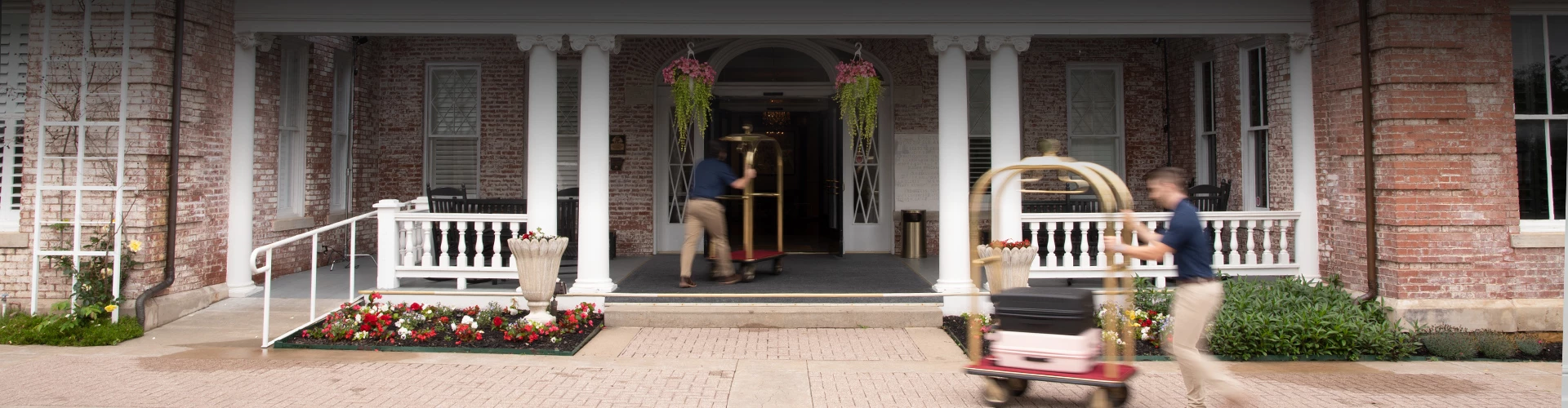 a man pushing a cart in front of a building