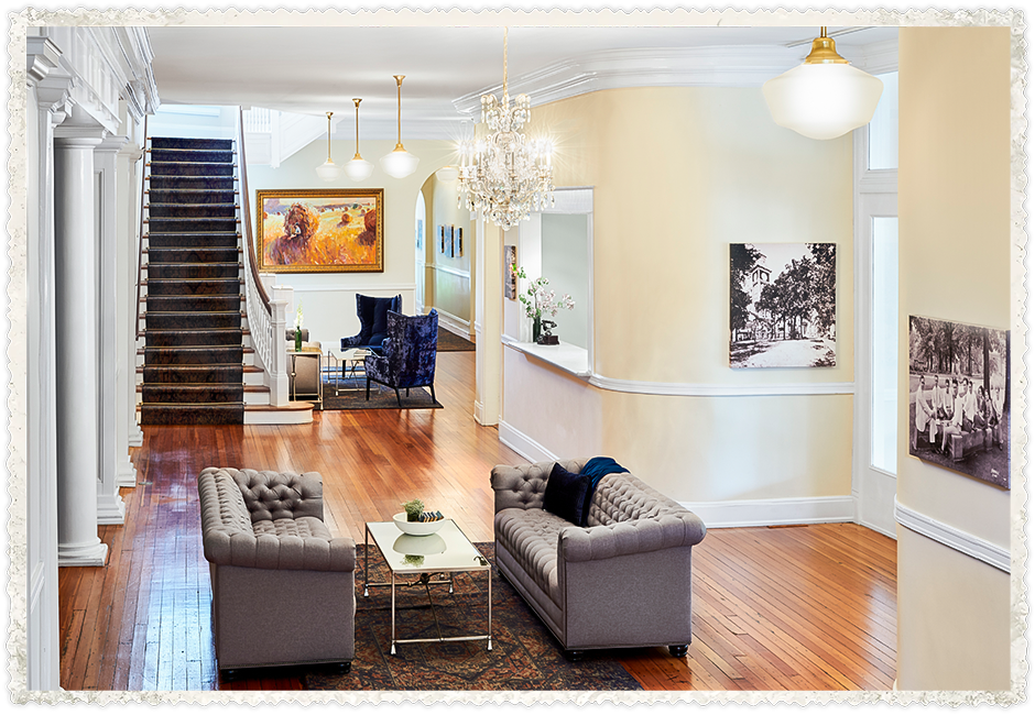 a living room with a chandelier and couches