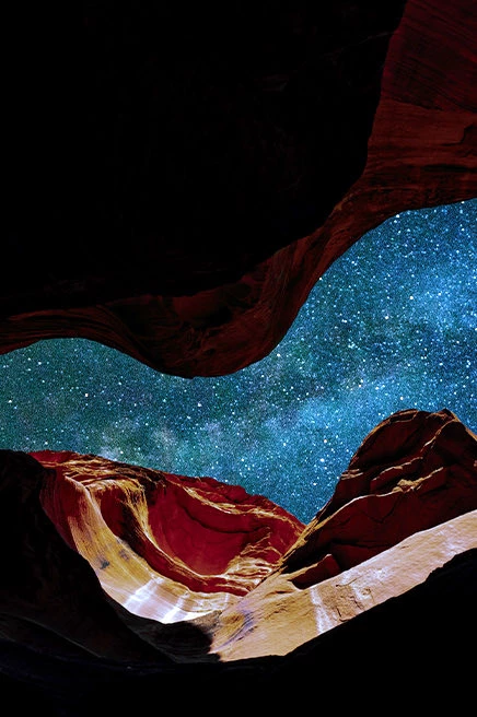 upward shot of starry sky in between rocky walls