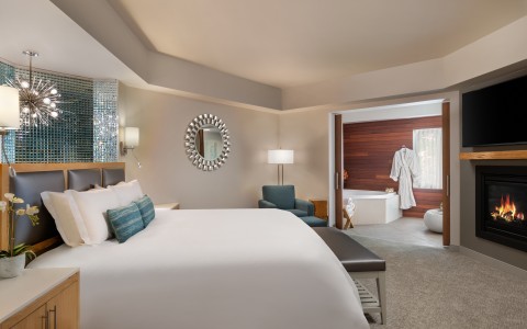 Inn at the 5th King Spa Suite featuring a luxurious king sized bed, cozy fireplace and spa with soaker tub
