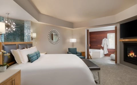 Inn at the 5th King Spa Suite featuring a luxurious king sized bed, cozy fireplace and spa with soaker tub