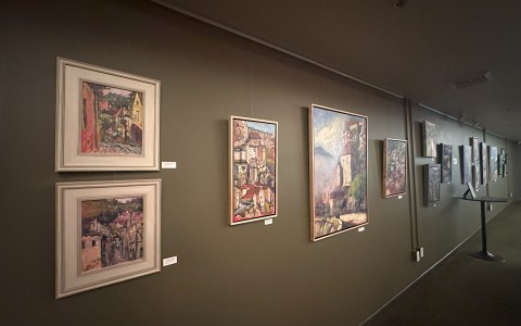 a hallway with art by Margaret Plumb on the wall