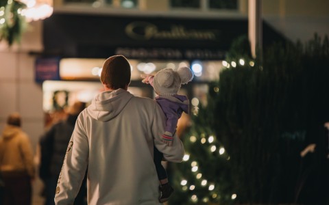 a man carrying a baby