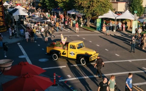 a yellow truck with a woman in the back on the side of it
