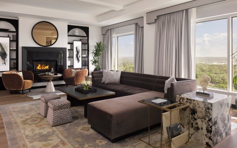 a living room with a large couch and a fireplace