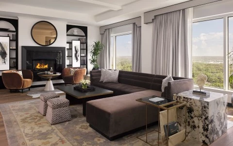 a living room with a large couch and a fireplace