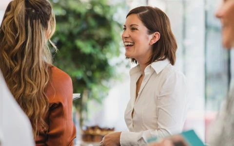 a woman laughing at another woman