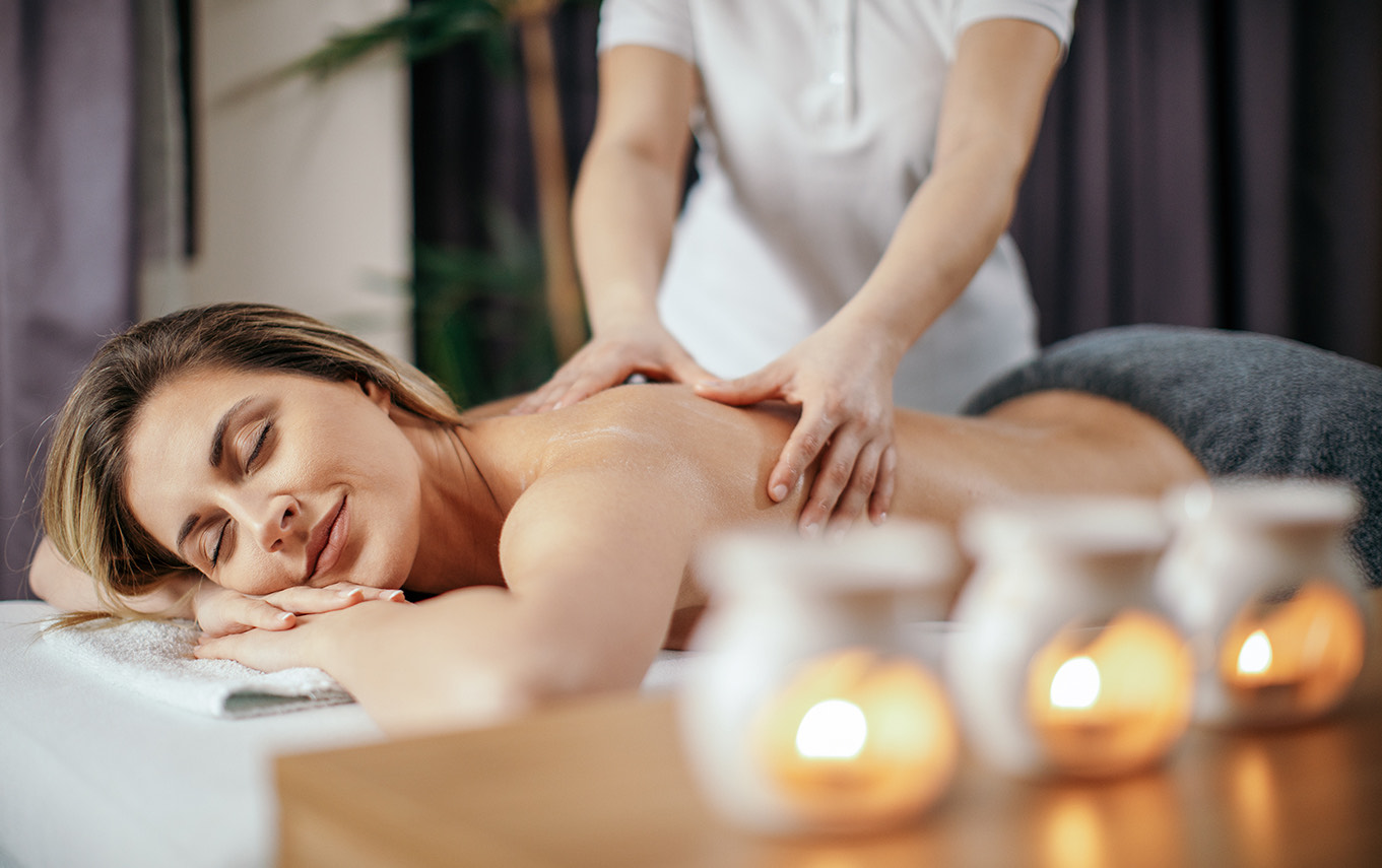 Image One Info a person lying on a table with candles