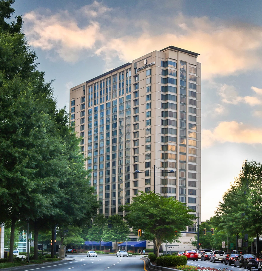 Image One Info a tall building with trees and cars on the street