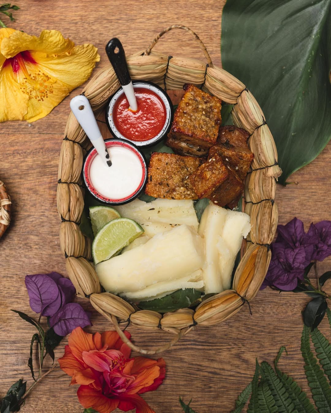 a basket of food with sauces and fruits