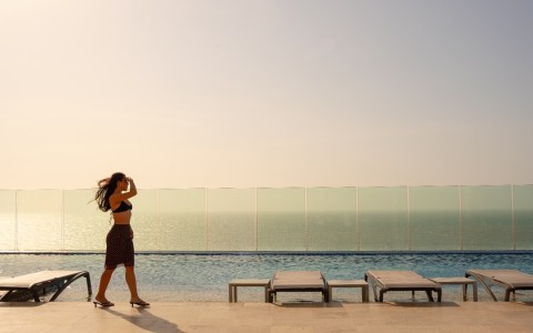 a woman standing near a pool