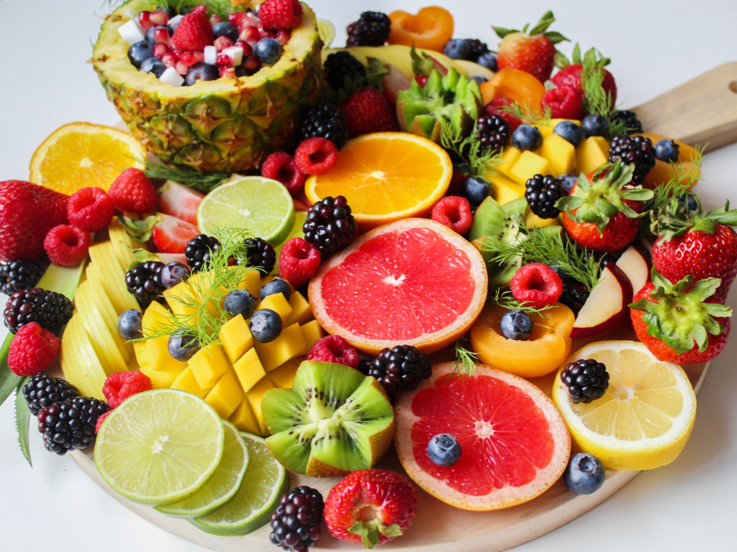 a plate of fruit on a white surface