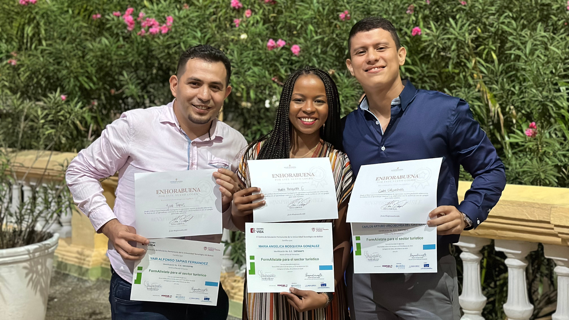 a group of people holding certificates