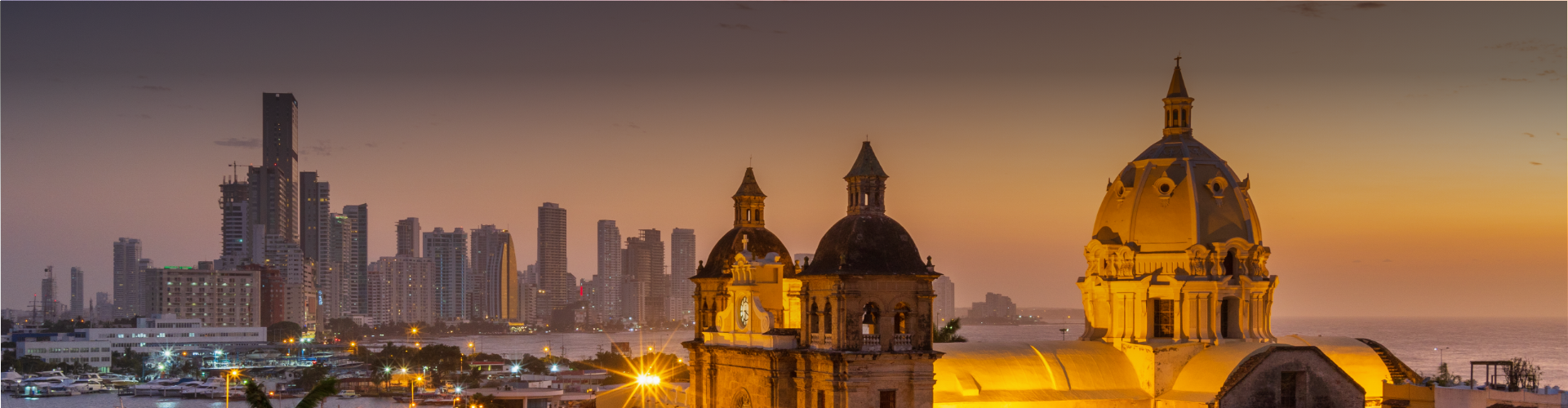 a building with a clock on top and a city skyline