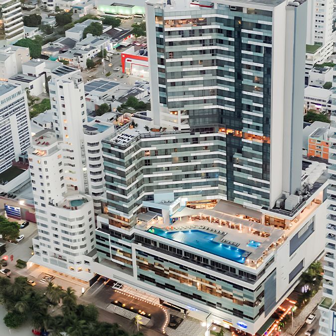 a high rise building with a pool in the middle of a city