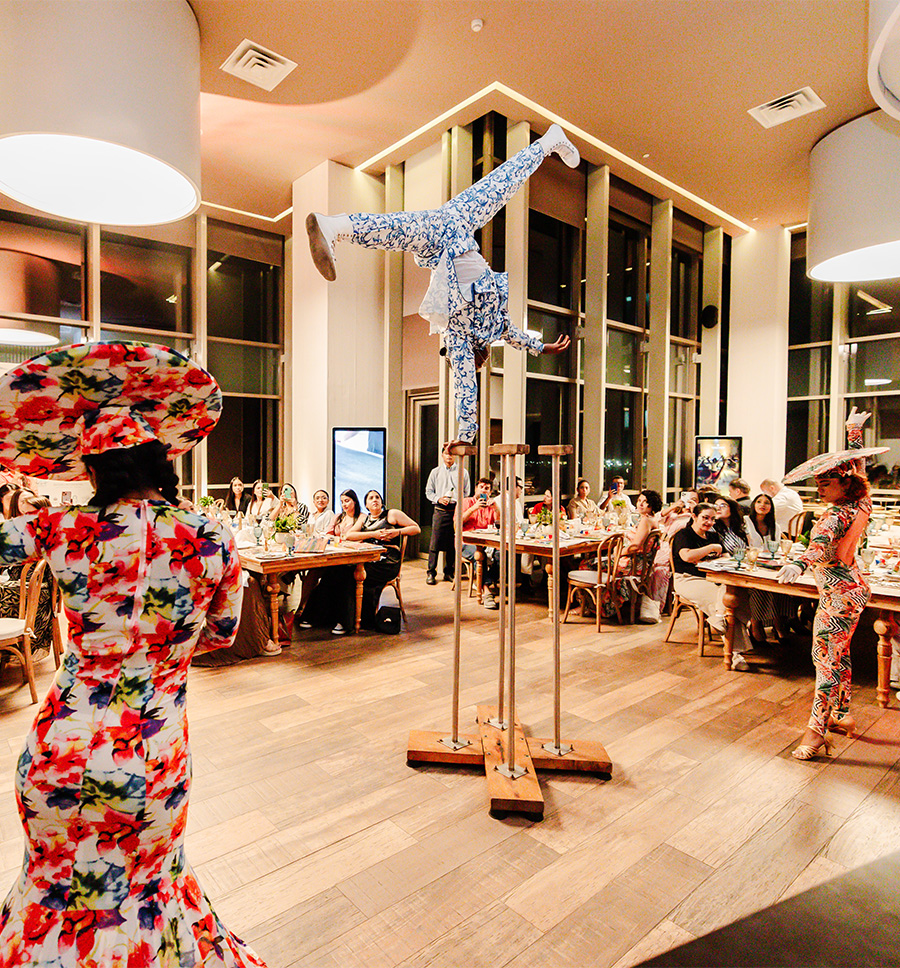 a group of people in a room with tables and chairs
