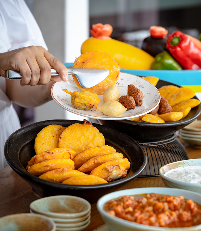 a person holding a plate of food