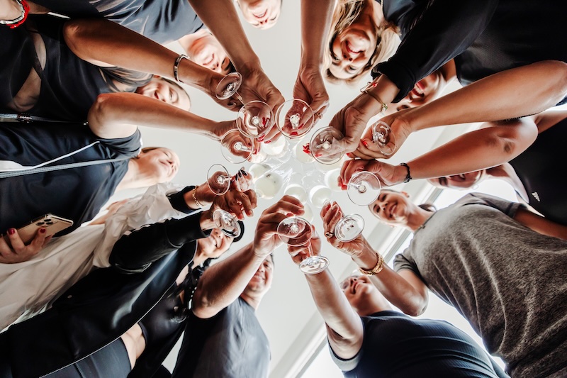 a group of people holding wine glasses
