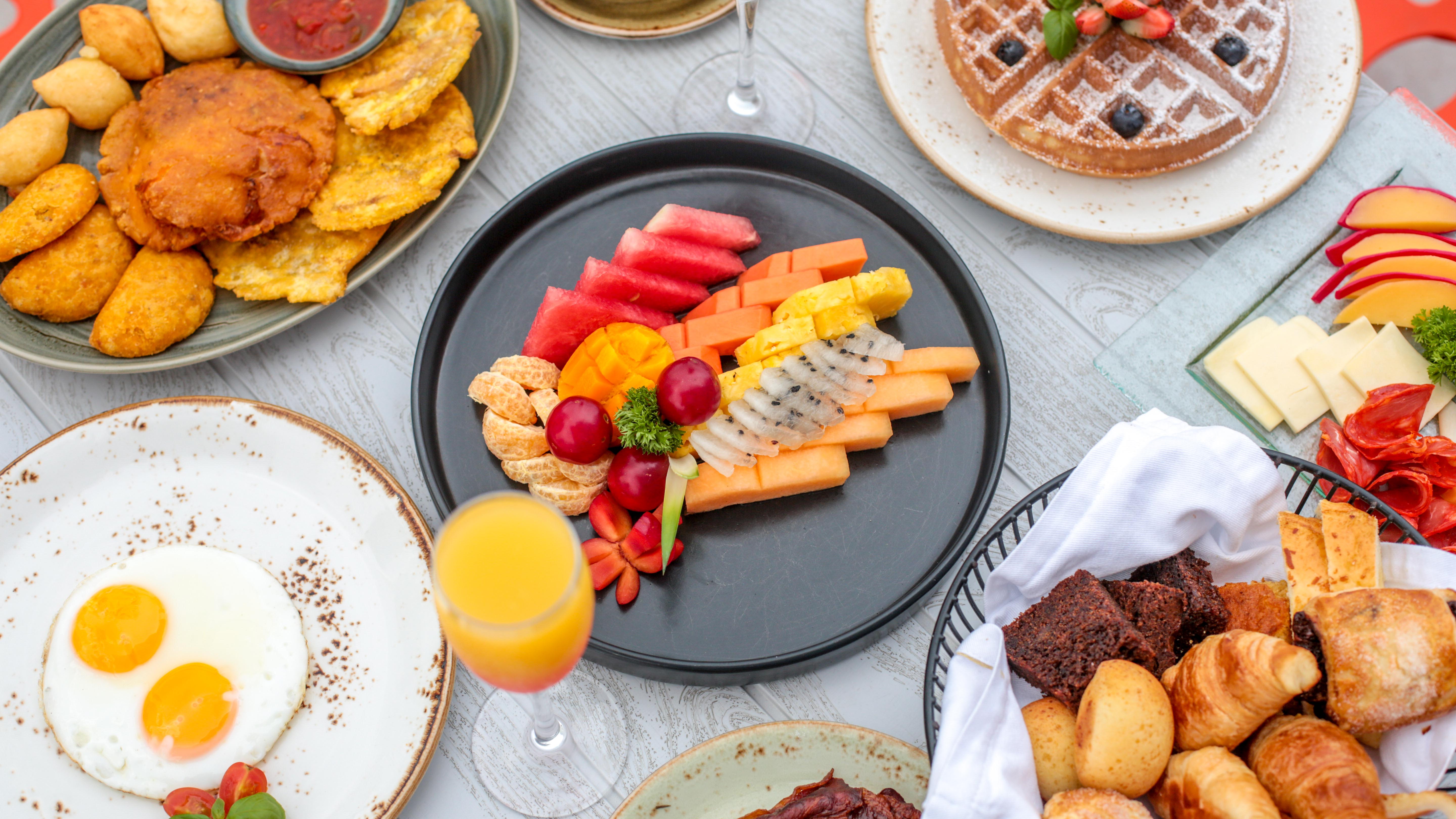 a plate of fruit and waffles on a table