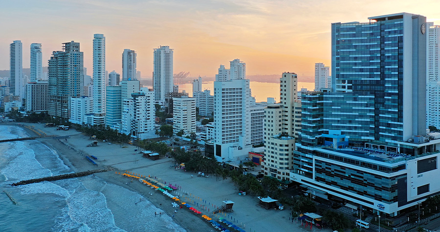 a city with many tall buildings and a beach