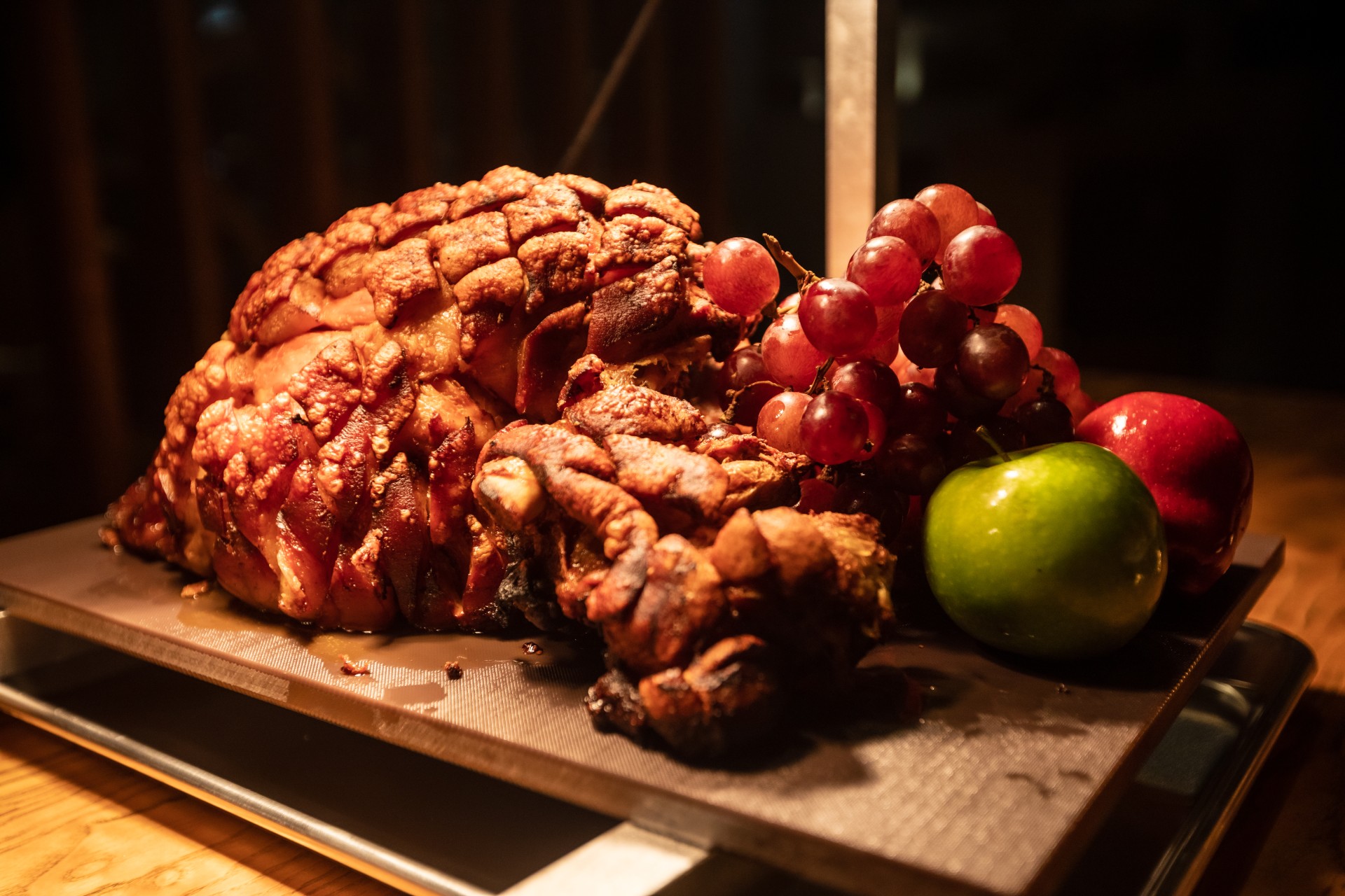 a meat and fruit on a cutting board