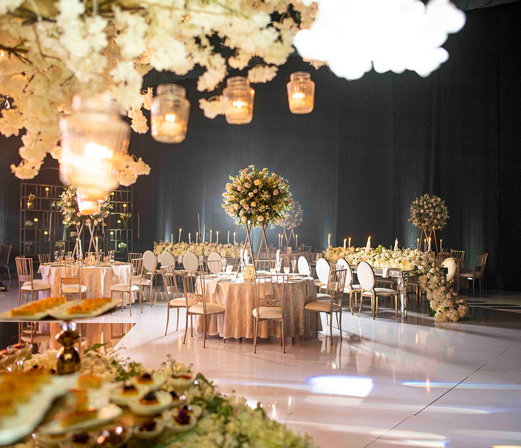 a room with tables and chairs and flowers