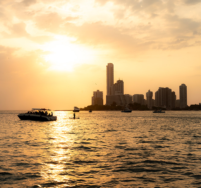a boat in the water with a city in the background