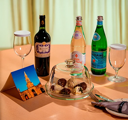 a table with wine and chocolates