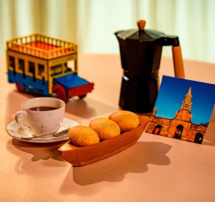 a cup of coffee and a picture of a trolley and a picture of a bus