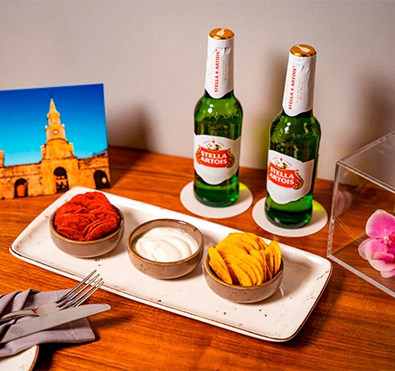 a table with a tray of food and bottles