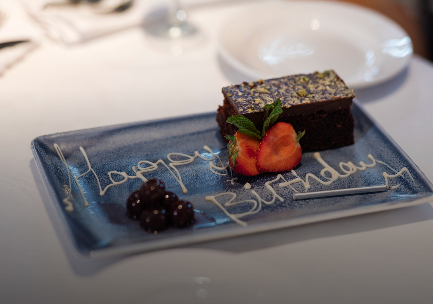 a plate with a piece of cake and strawberries